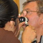 ULHT dermatologist Dr Caroline Angit examining a mark on Leonard Andrews’ face