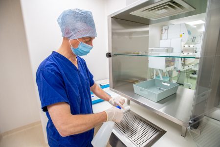 A technician disinfects pharmaceutical products