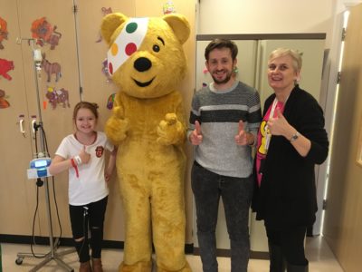 Pudsey bear with staff and family