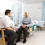 Patient and man in ward