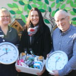 Photo of Cathie Alcock, Jane Walton and Andy Storey with the bird tables and holding the clocks.