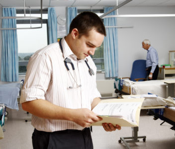 A doctor consulting a patient's notes