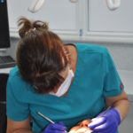 Photo of Joy treating a patient in the orthodontic suite