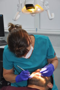 Photo of Joy treating a patient in the orthodontic suite