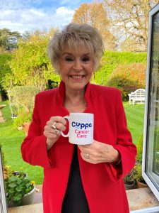 Gloria holds a Hope for Tomorrow charity mug