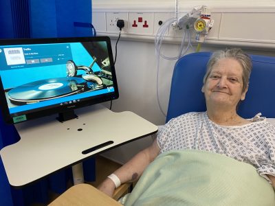 Betty Hester listening to Elvis with RITA at Lincoln County Hospital