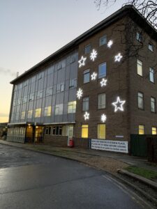 A building with bright white star shaped lights hung outside