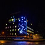 A building with bright white star shaped lights hung outside