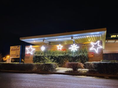 A building with bright white star shaped lights hung outside