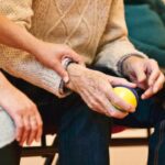 Woman holding an arm of and an older man.