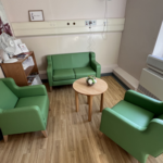 emerald suite in Grantham. Room with green sofas and chairs