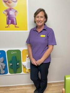 Sandy, standing smiling at the camera