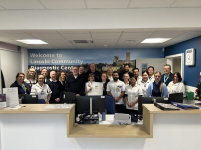A group of people standing together smiling. 