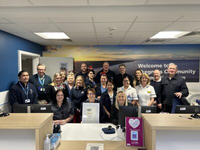 A group of people standing together smiling. 