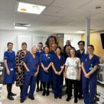 A group of people standing together smiling.