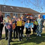 children stood with books in hands