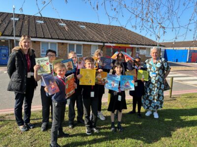 children stood with books in hands