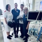 four nurses stood in a hospital ward