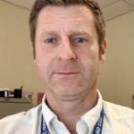 Photo of Paul Clark, looking at the camera