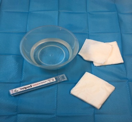Step 2 Pour the cool boiled water or saline solution into a clean bowl and prepare the gauze or cotton buds.
