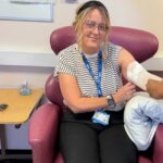 lady sat on a chair receiving injection
