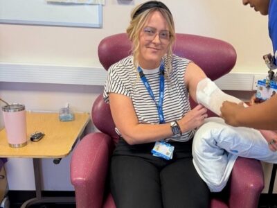 lady sat on a chair receiving injection