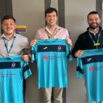 three football players holding football shirts