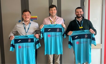three football players holding football shirts